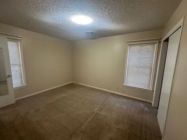 an empty room with a empty space and windows