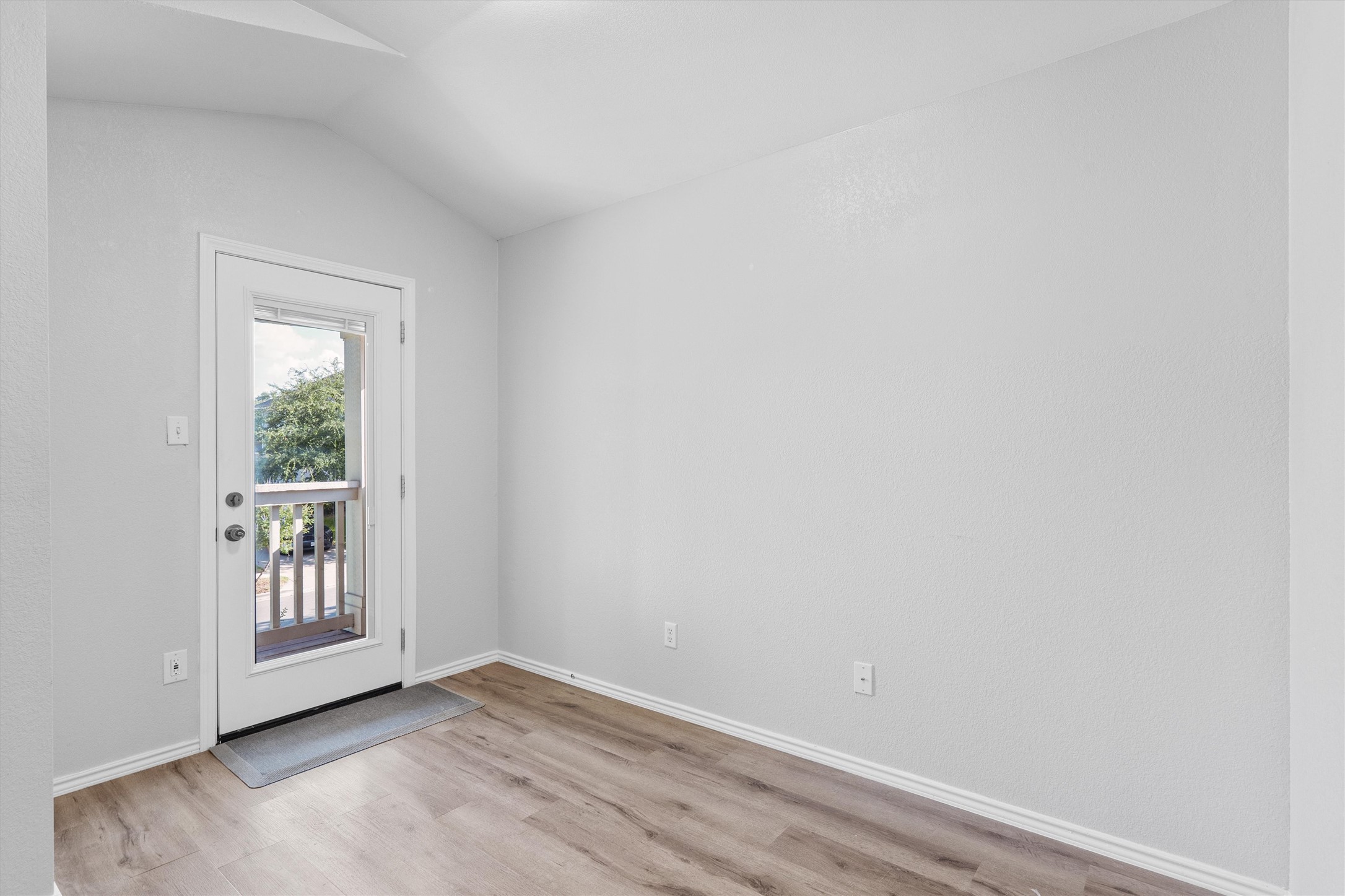 1833 Thompson Trail Round Rock, TX 78664 - Photo 19 of 40 A private outdoor space awaits through the glass-paneled door, complementing the clean interior with resilient wood-look flooring.