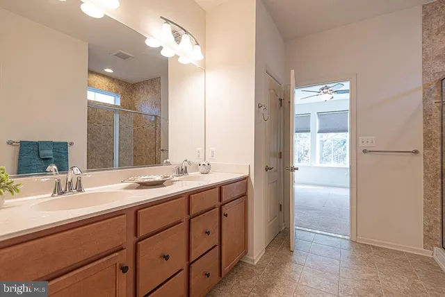 a kitchen with kitchen island granite countertop a refrigerator oven a sink with wooden cabinets and floor