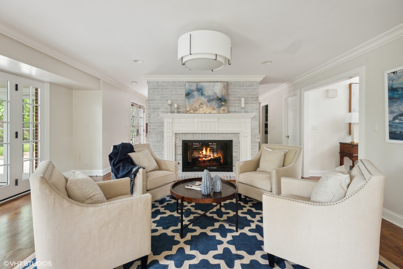 2420 Dorina Drive Northfield, IL 60093 - Photo 12 of 51 a living room with furniture a fireplace and a chandelier