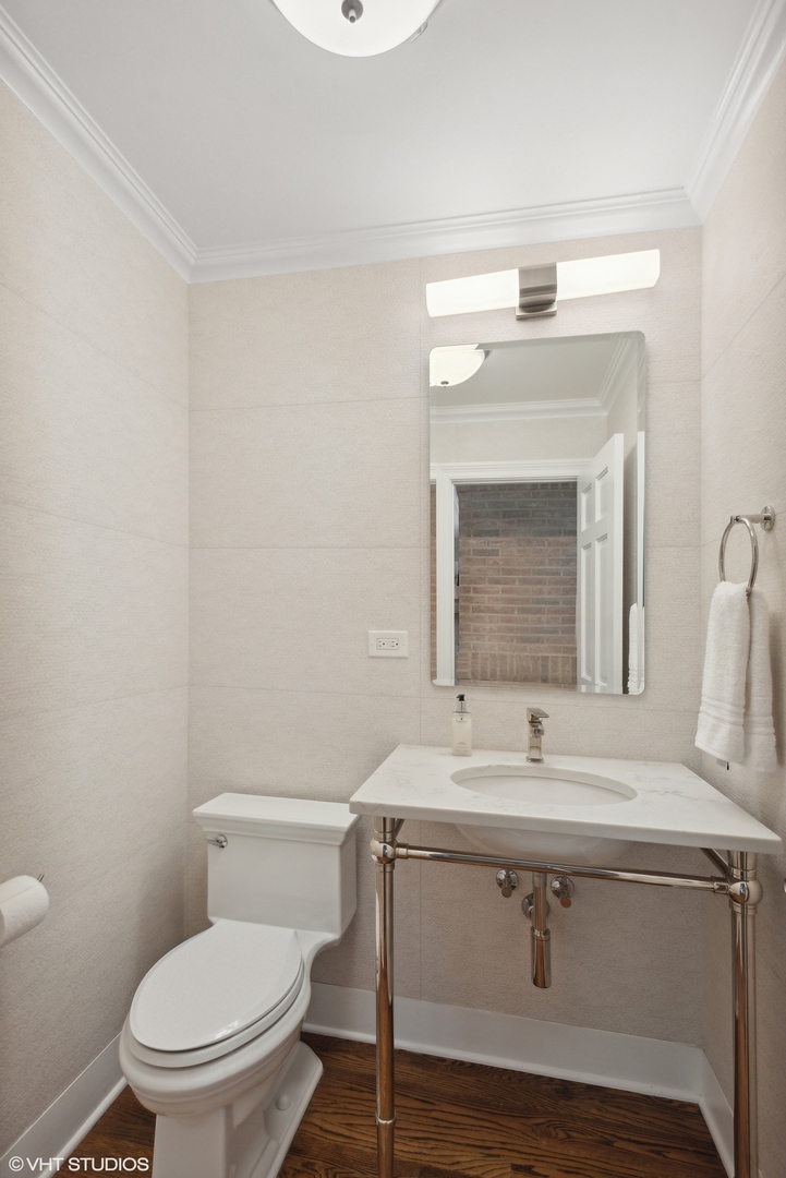 2420 Dorina Drive Northfield, IL 60093 - Photo 23 of 51 a bathroom with a sink toilet and mirror