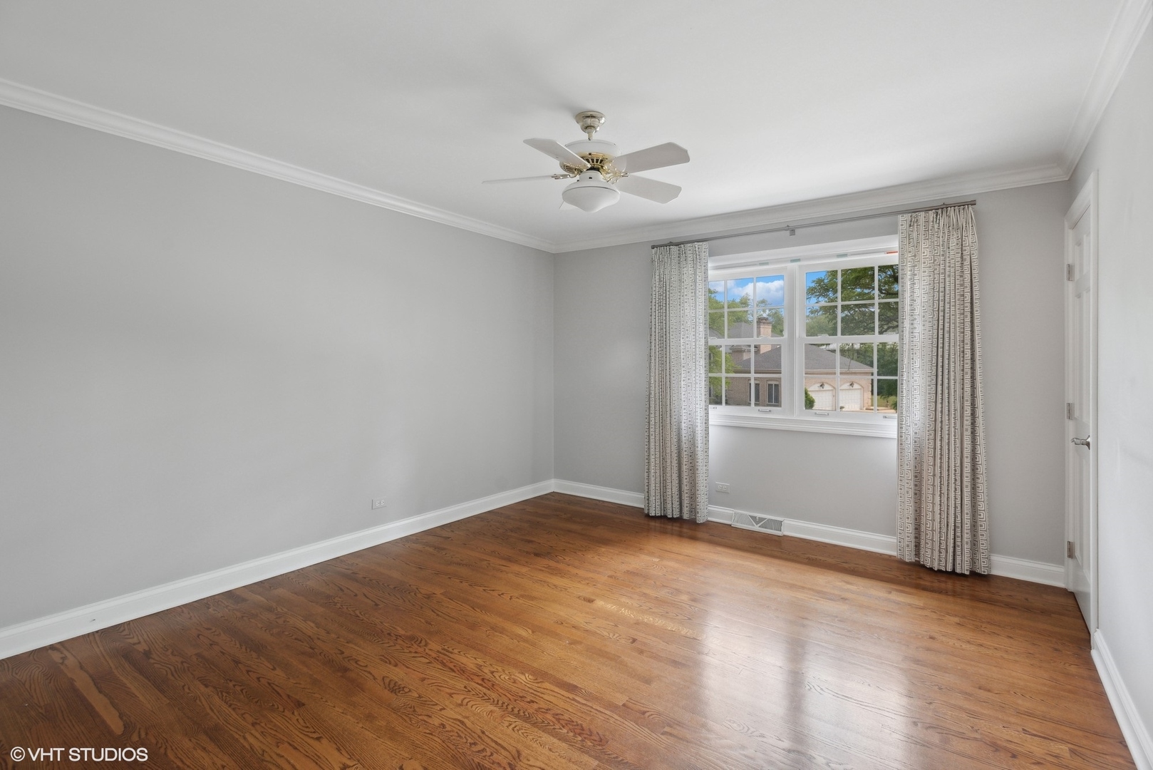 2420 Dorina Drive Northfield, IL 60093 - Photo 37 of 51 an empty room with wooden floor fan and windows