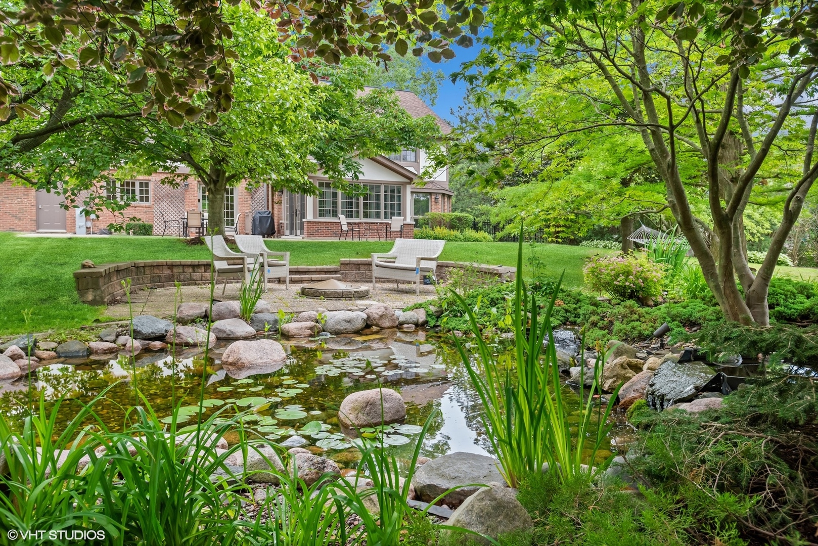 2420 Dorina Drive Northfield, IL 60093 - Photo 40 of 51 a view of a garden with a fountain