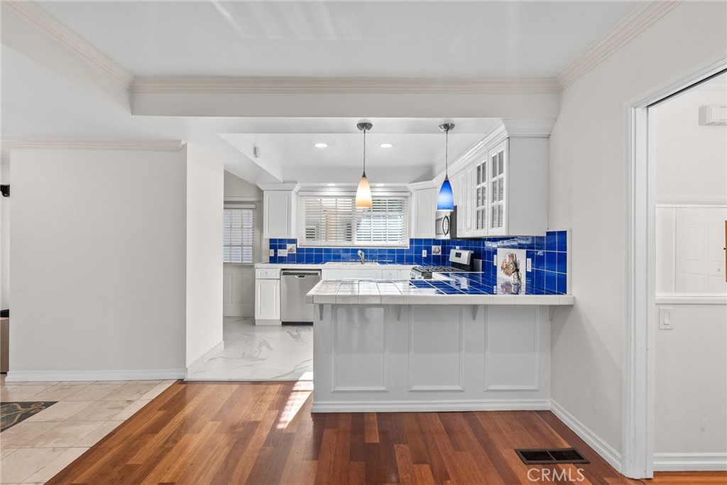 1519 Lynglen Drive Glendale, CA 91206 - Photo 13 of 39 a open kitchen with white cabinets and wooden floor