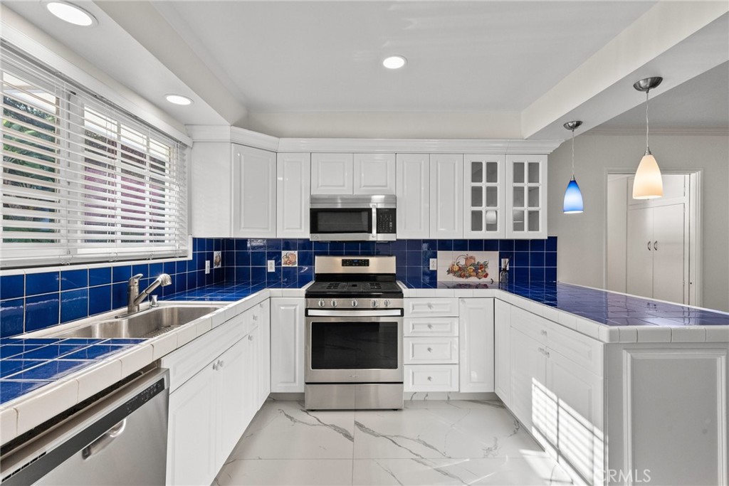 1519 Lynglen Drive Glendale, CA 91206 - Photo 15 of 39 a kitchen with granite countertop a stove sink and cabinets