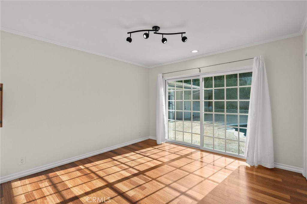 1519 Lynglen Drive Glendale, CA 91206 - Photo 19 of 39 a view of empty room with wooden floor and fan