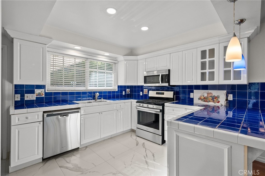 1519 Lynglen Drive Glendale, CA 91206 - Photo 3 of 39 a kitchen with stainless steel appliances granite countertop a stove sink and microwave