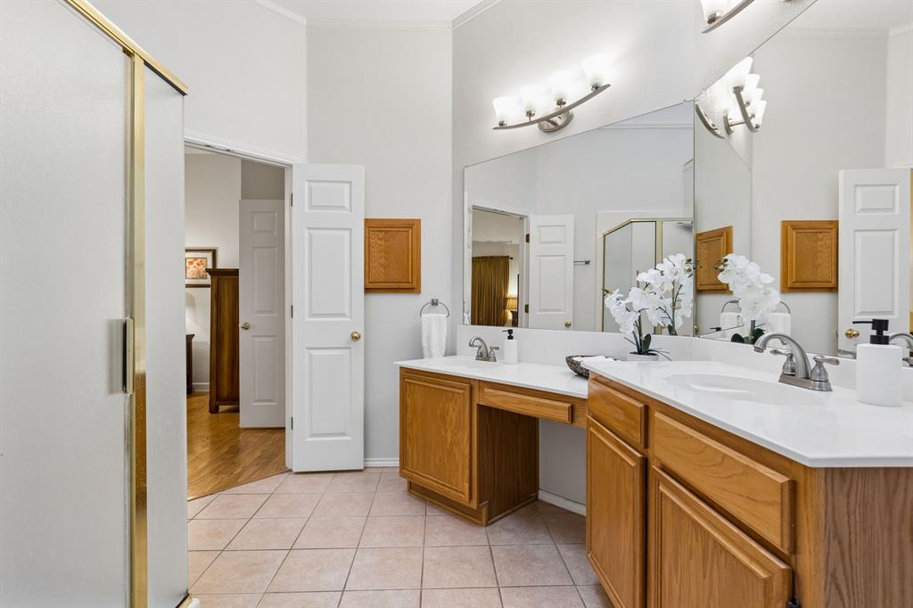 915 Rutgers Court Allen, TX 75002 - Photo 23 of 39 This view of the primary shows the updated light fixtures and the separate shower. The open feel of the room is enhanced by the high ceiling and SKYLIGHT! Gorgeous light floods the room during the daytime!