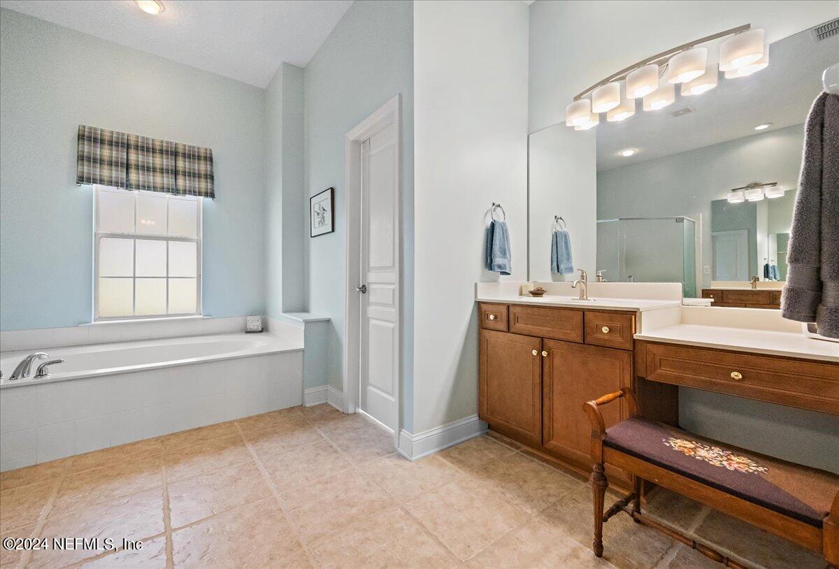 757 Eagle Point Drive St. Augustine, FL 32092 - Photo 17 of 44 a spacious bathroom with a tub sink shower and mirror