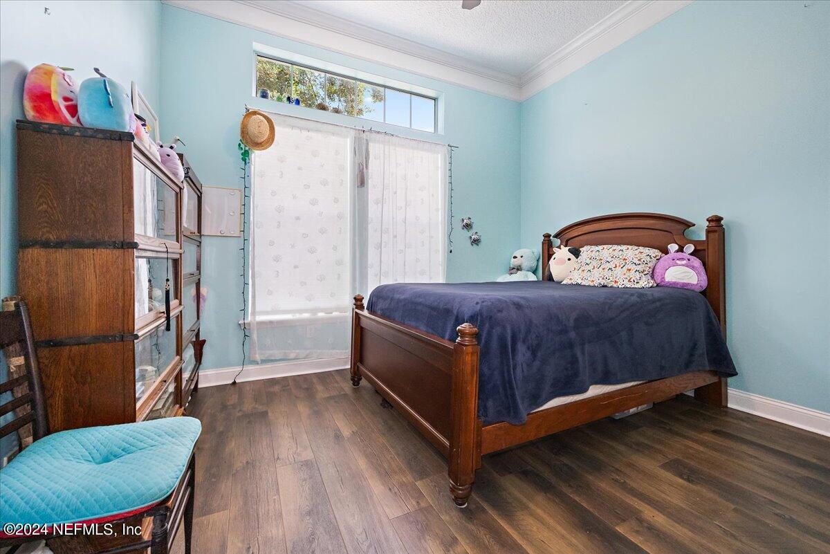 757 Eagle Point Drive St. Augustine, FL 32092 - Photo 18 of 44 a bedroom with a bed and a table in it