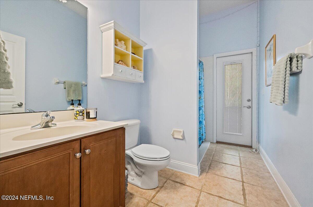 757 Eagle Point Drive St. Augustine, FL 32092 - Photo 19 of 44 a bathroom with a sink a toilet and shower