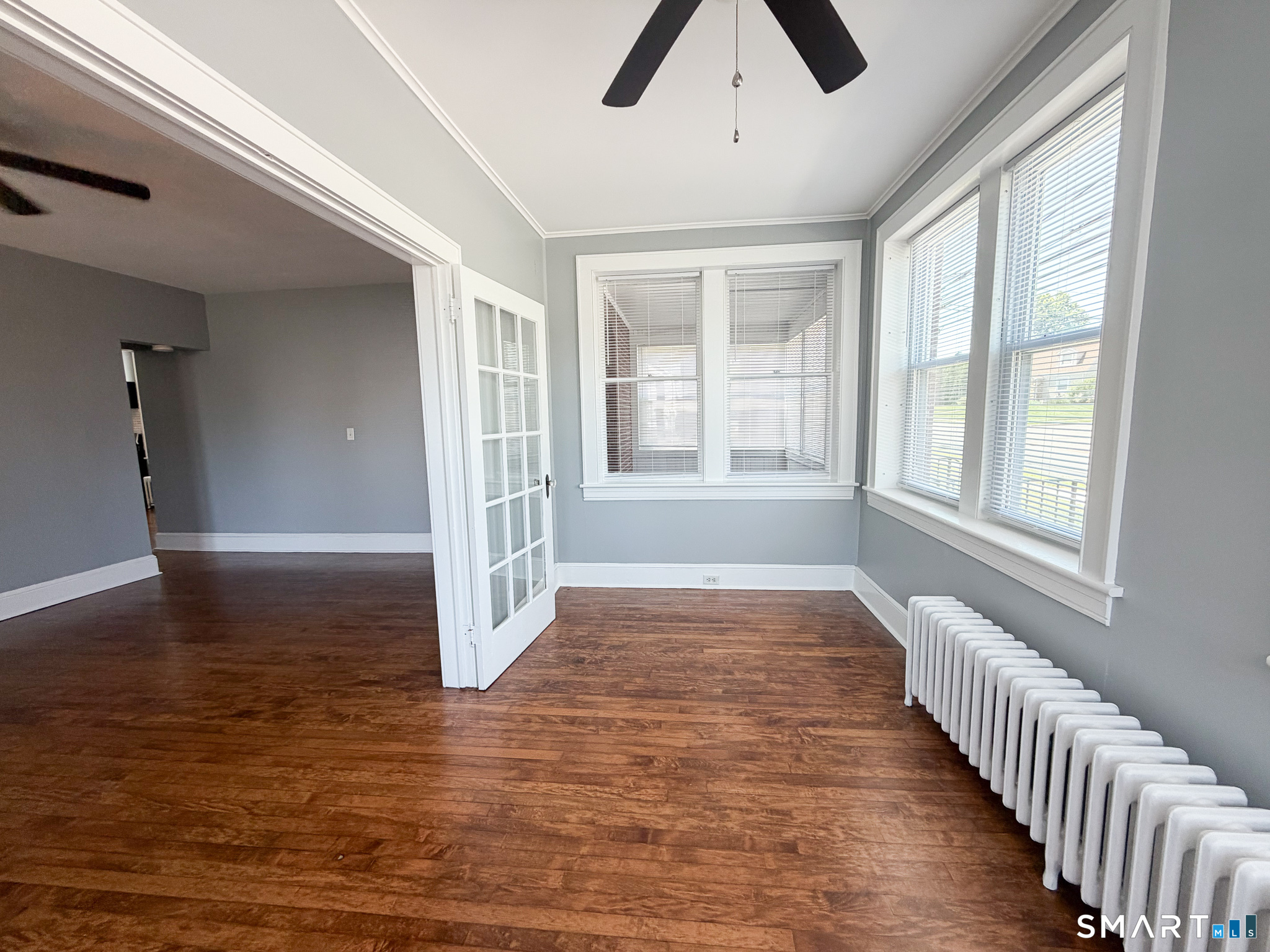 793 Milford Point Road, Unit 1 Milford, CT 06460 - Photo 8 of 16 wooden floor in an empty room with a window