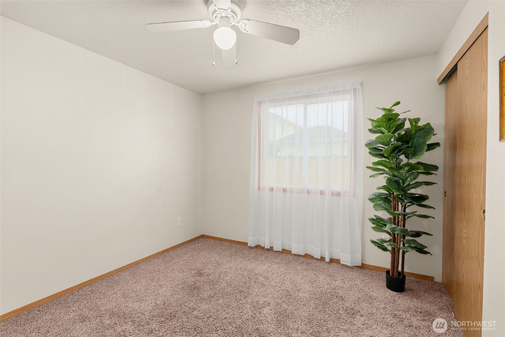 118 Rose Marie Drive Chehalis, WA 98532 - Photo 21 of 27 an empty room with potted plants and wooden floor