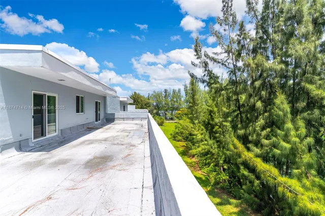 a view of a house with a flower garden