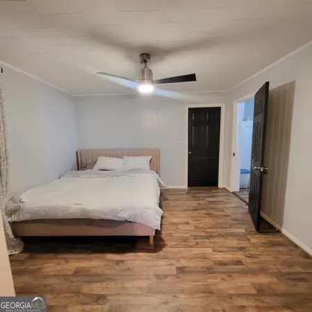 a bedroom with a bed and a ceiling fan