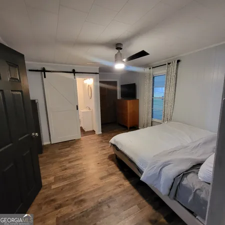 a bed room with a bed and a large mirror