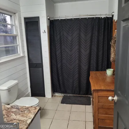 a bathroom with a toilet and shower