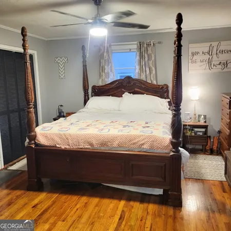 a bed sitting in a bedroom next to a window