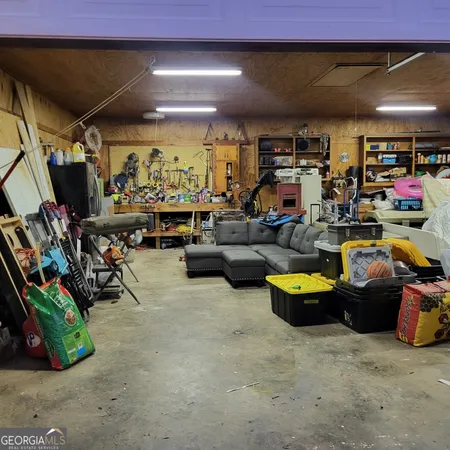 a living room with lots of furniture and clutter