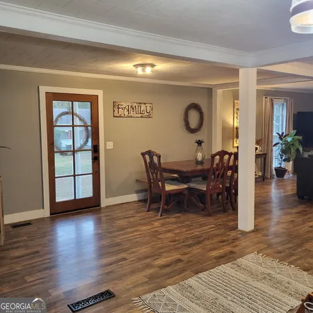a view of a dining room with furniture and wooden floor