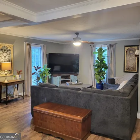 a living room with furniture and a flat screen tv