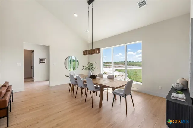 a view of a dining room with furniture window and wooden floor