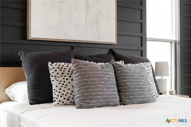 a bed sitting in a bedroom next to a window