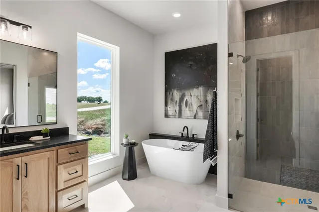 a large spacious bathroom with a bathtub and a sink