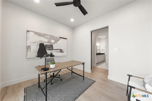 a view of hallway wooden floor and a chandelier