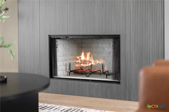 a room with wooden floor and a fireplace