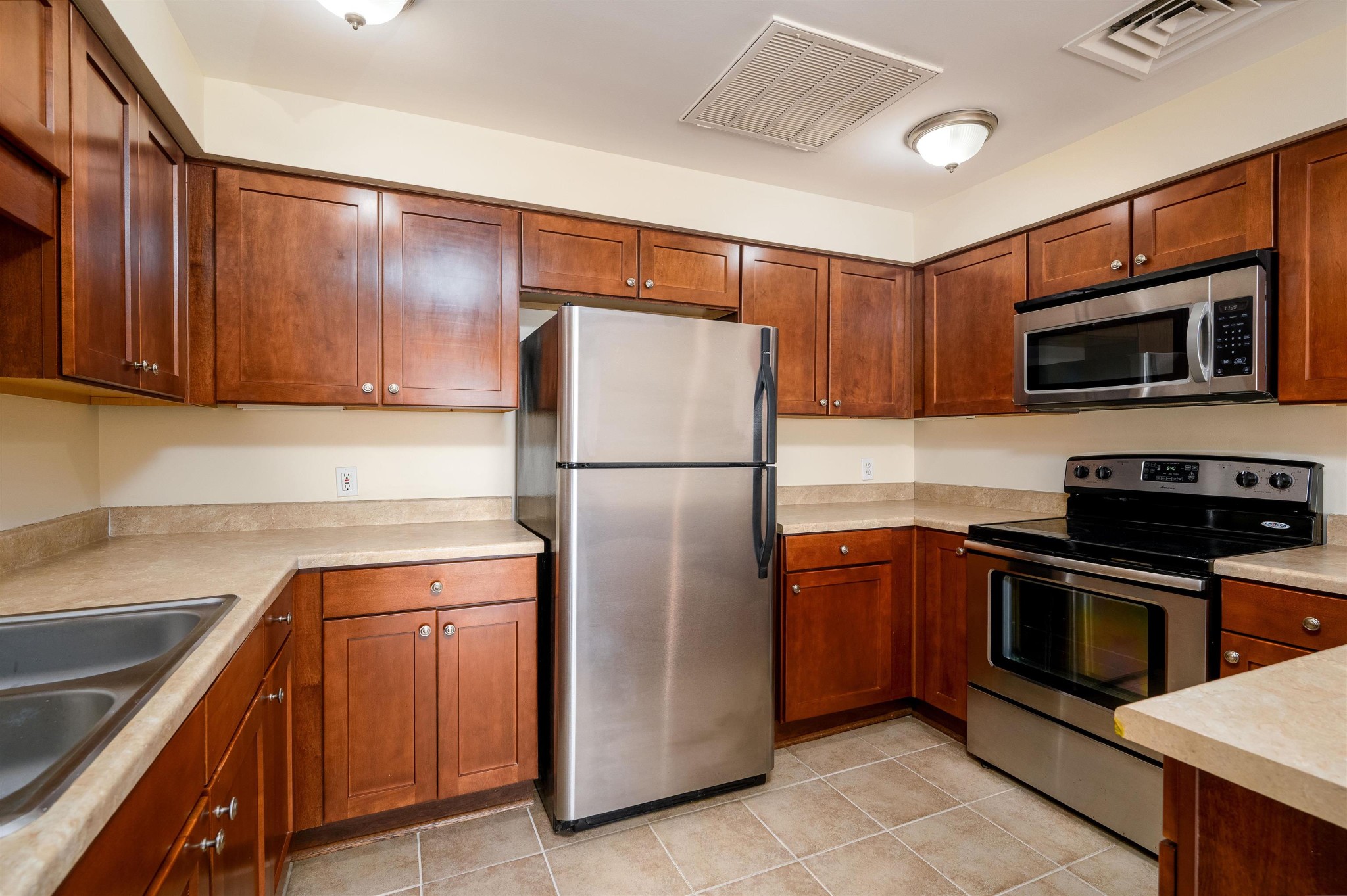 655 Riverside Drive, Unit 606A Memphis, TN 38103 - Photo 3 of 35 a kitchen with stainless steel appliances granite countertop a refrigerator stove and microwave