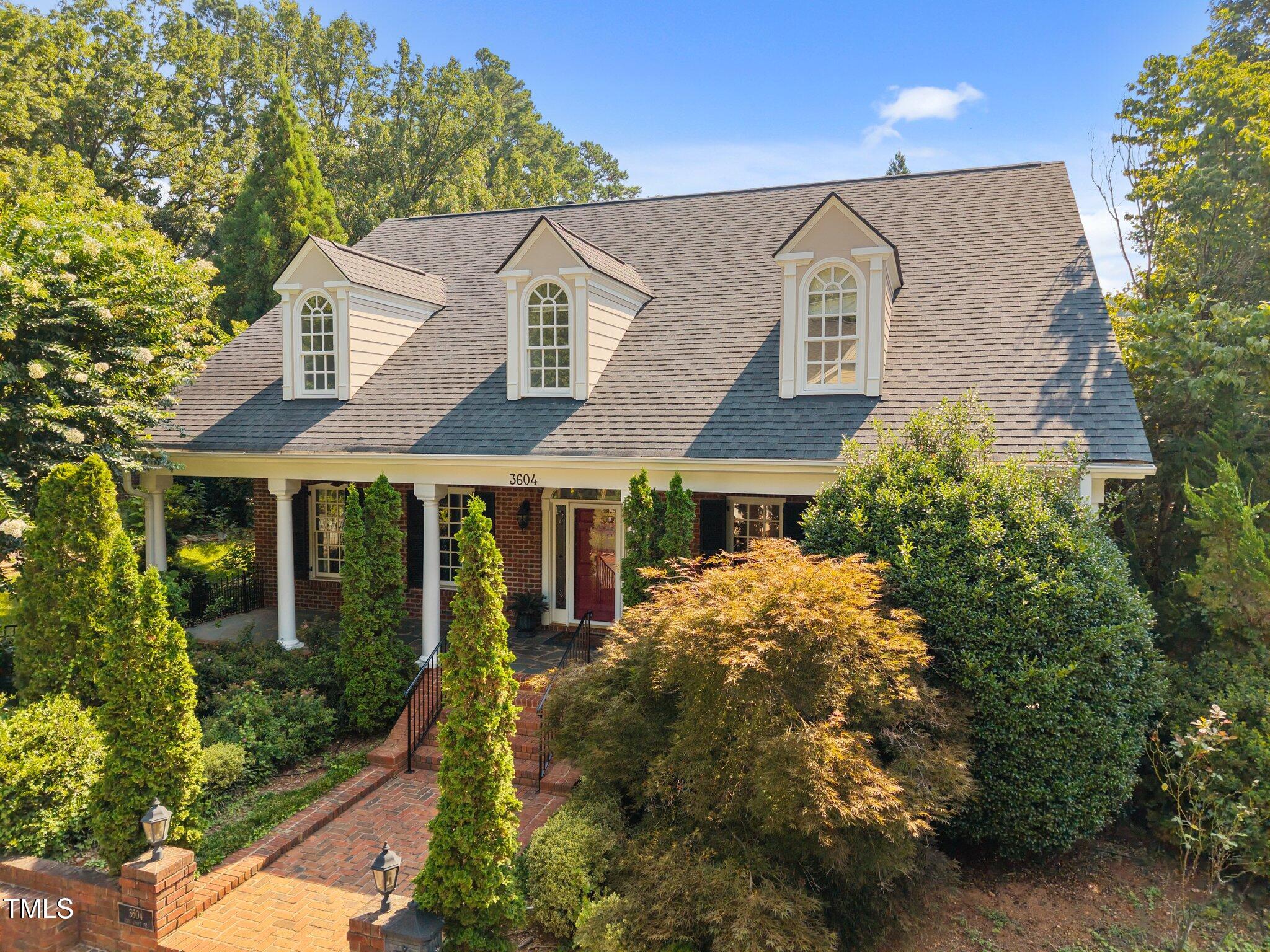 front view of house with a yard and potted plants
