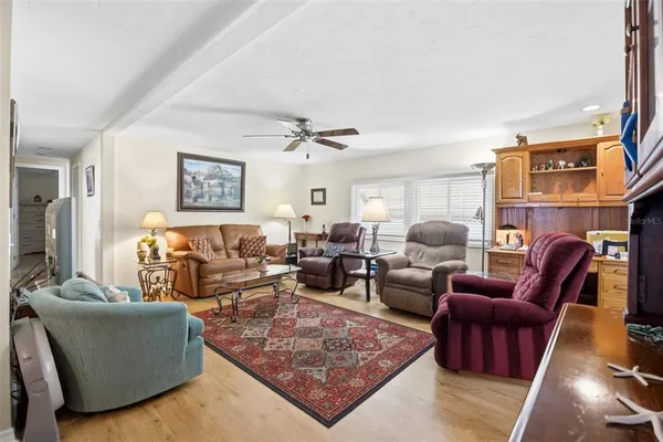a living room with furniture a rug and a window
