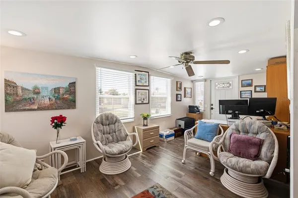 a living room with furniture a flat screen tv and a large window