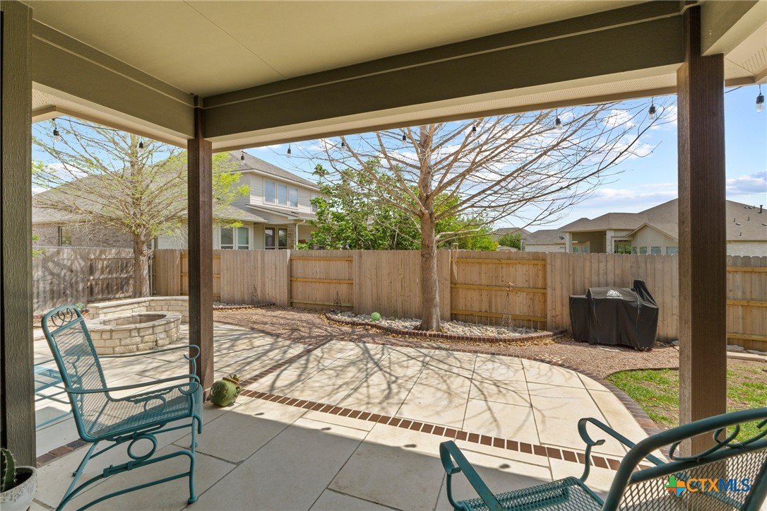 20525 Jackies Ranch Boulevard Pflugerville, TX 78660 - Photo 24 of 30 Fenced backyard with a patio area, an outdoor fire pit, and sitting area