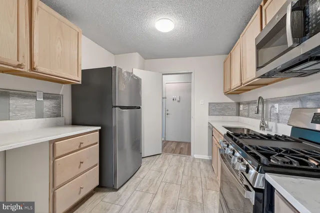 a kitchen with a stove and a refrigerator