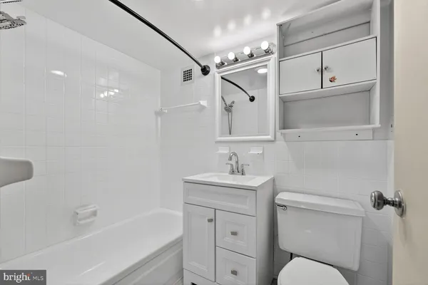 a bathroom with a toilet sink shower and bathtub