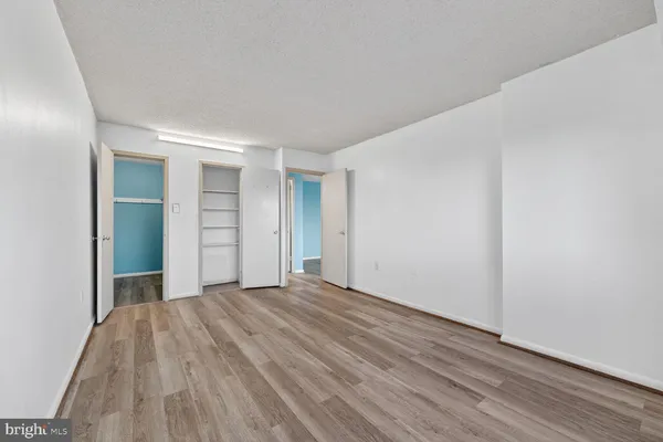 a view of a room with wooden floor