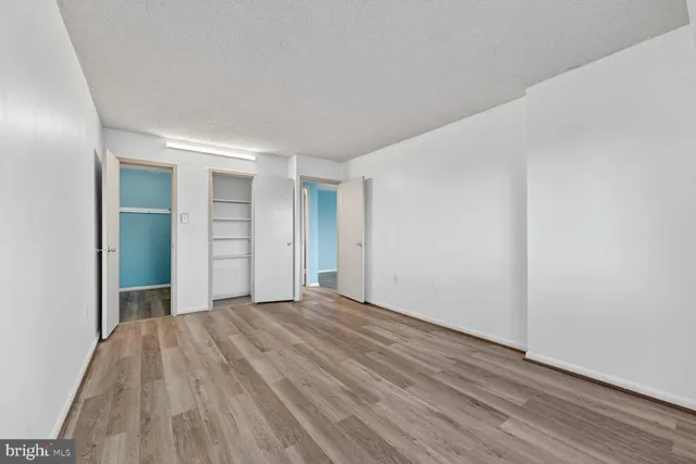 a view of a room with wooden floor