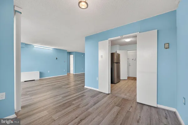a view of a room with wooden floor