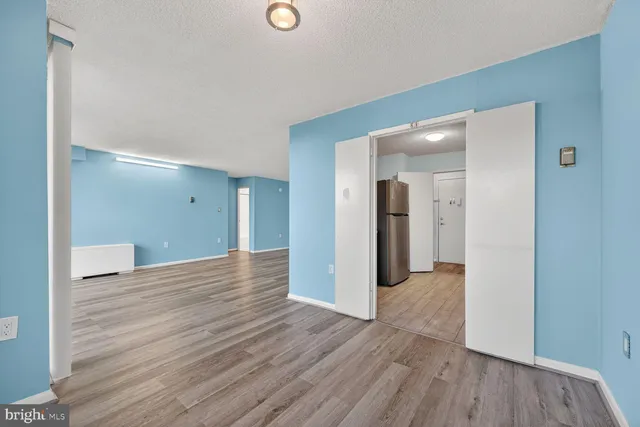 a view of a room with wooden floor