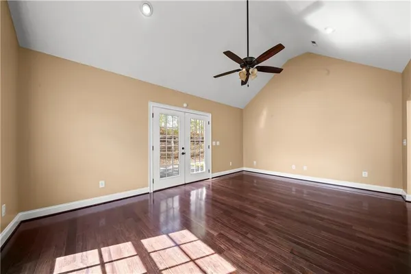 a spacious bedroom with a bed and a ceiling fan
