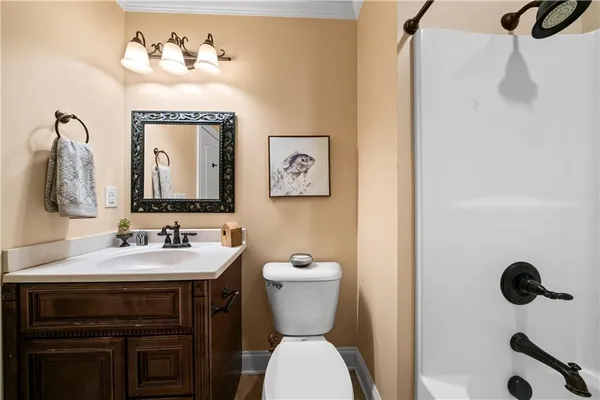 a bathroom with a sink a toilet and shower a mirror