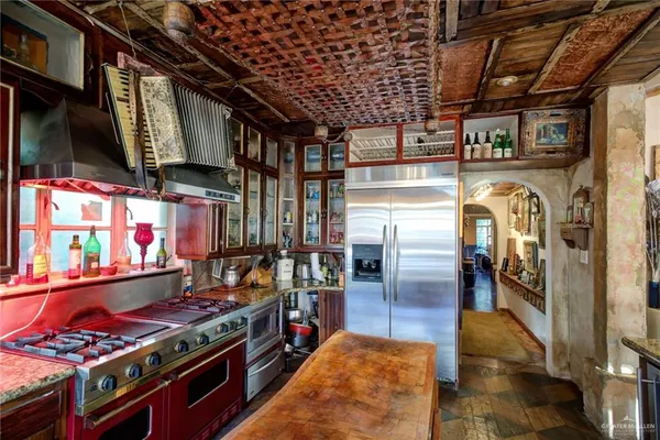 a kitchen with stainless steel appliances granite countertop a stove and a refrigerator