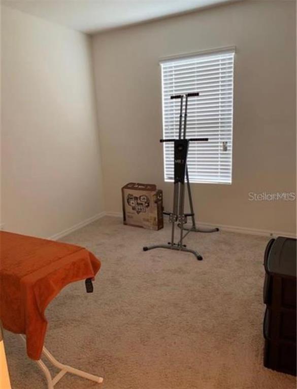 3740 Seneca Club Loop Orlando, FL 32808 - Photo 14 of 15 a room with gym equipment and a window