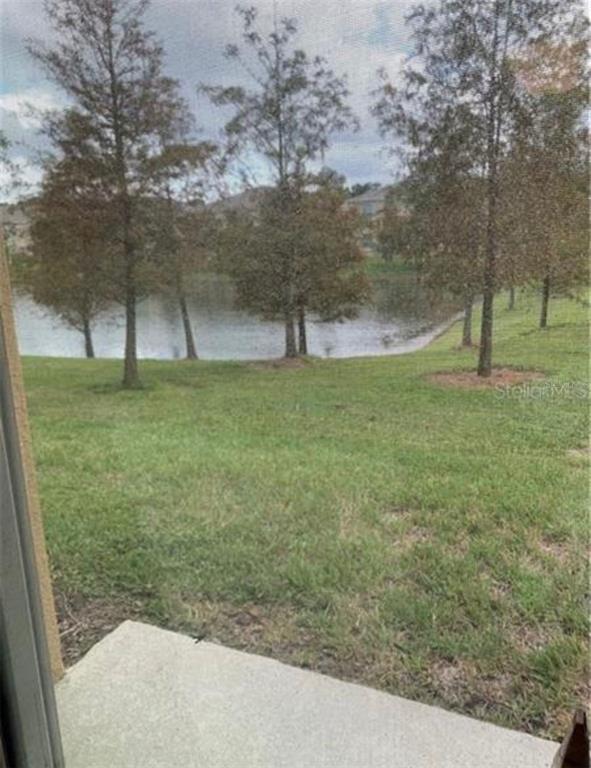 3740 Seneca Club Loop Orlando, FL 32808 - Photo 2 of 15 a view of a field with trees in the background