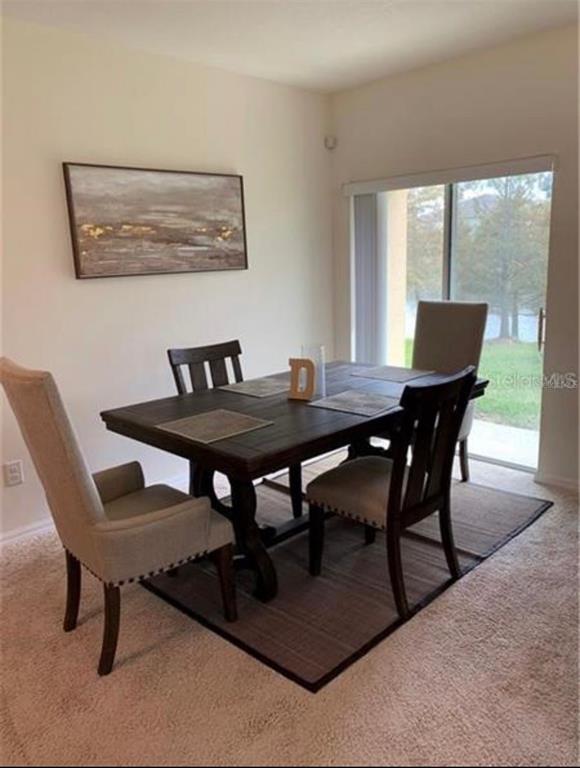 3740 Seneca Club Loop Orlando, FL 32808 - Photo 6 of 15 a view of a dining room with furniture window and outside view