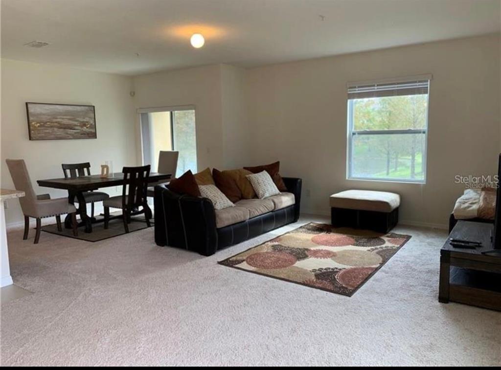 3740 Seneca Club Loop Orlando, FL 32808 - Photo 7 of 15 a living room with furniture rug and window