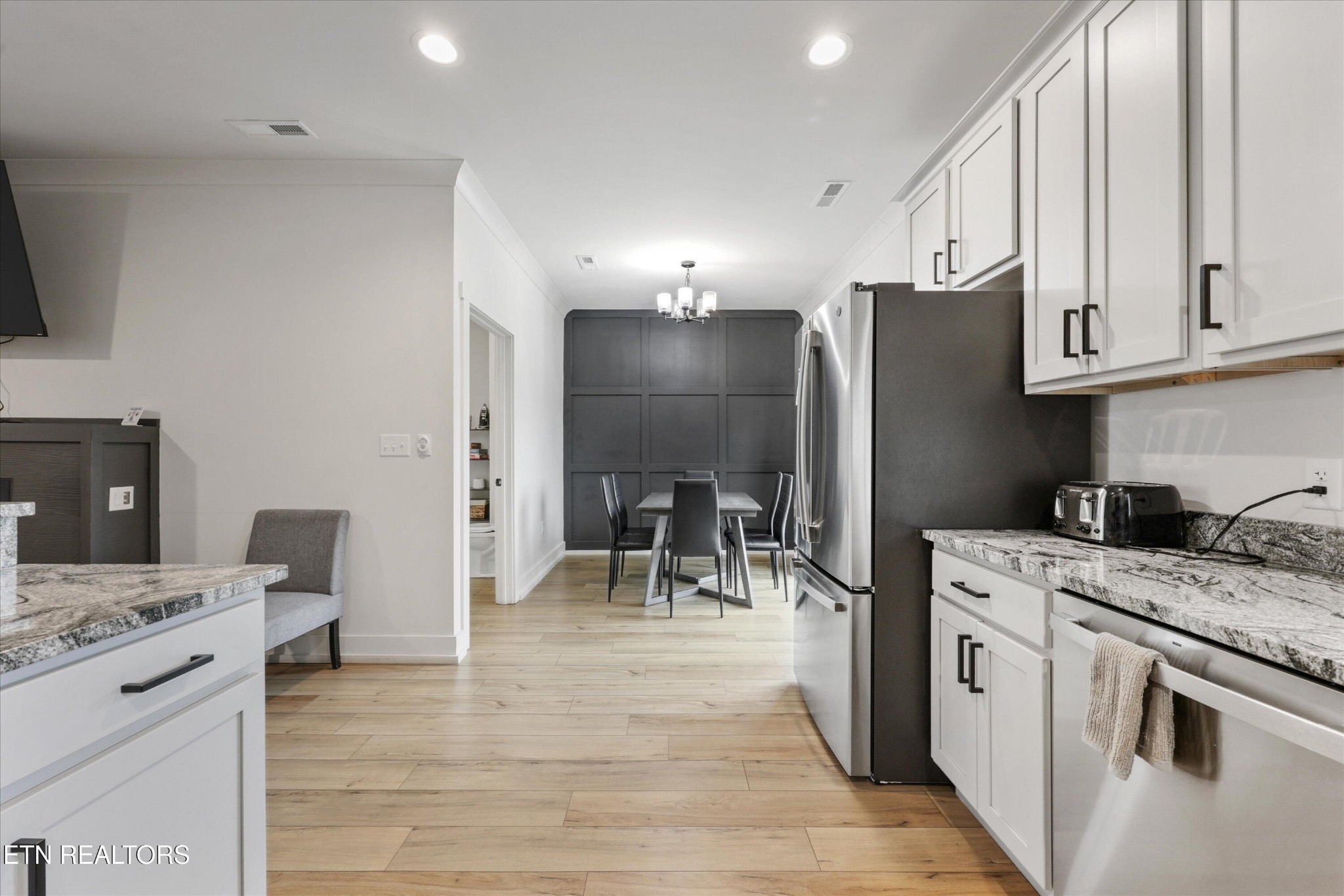 418 Fleeta Williams Way Sevierville, TN 37862 - Photo 11 of 39 a kitchen with a sink a refrigerator and chairs