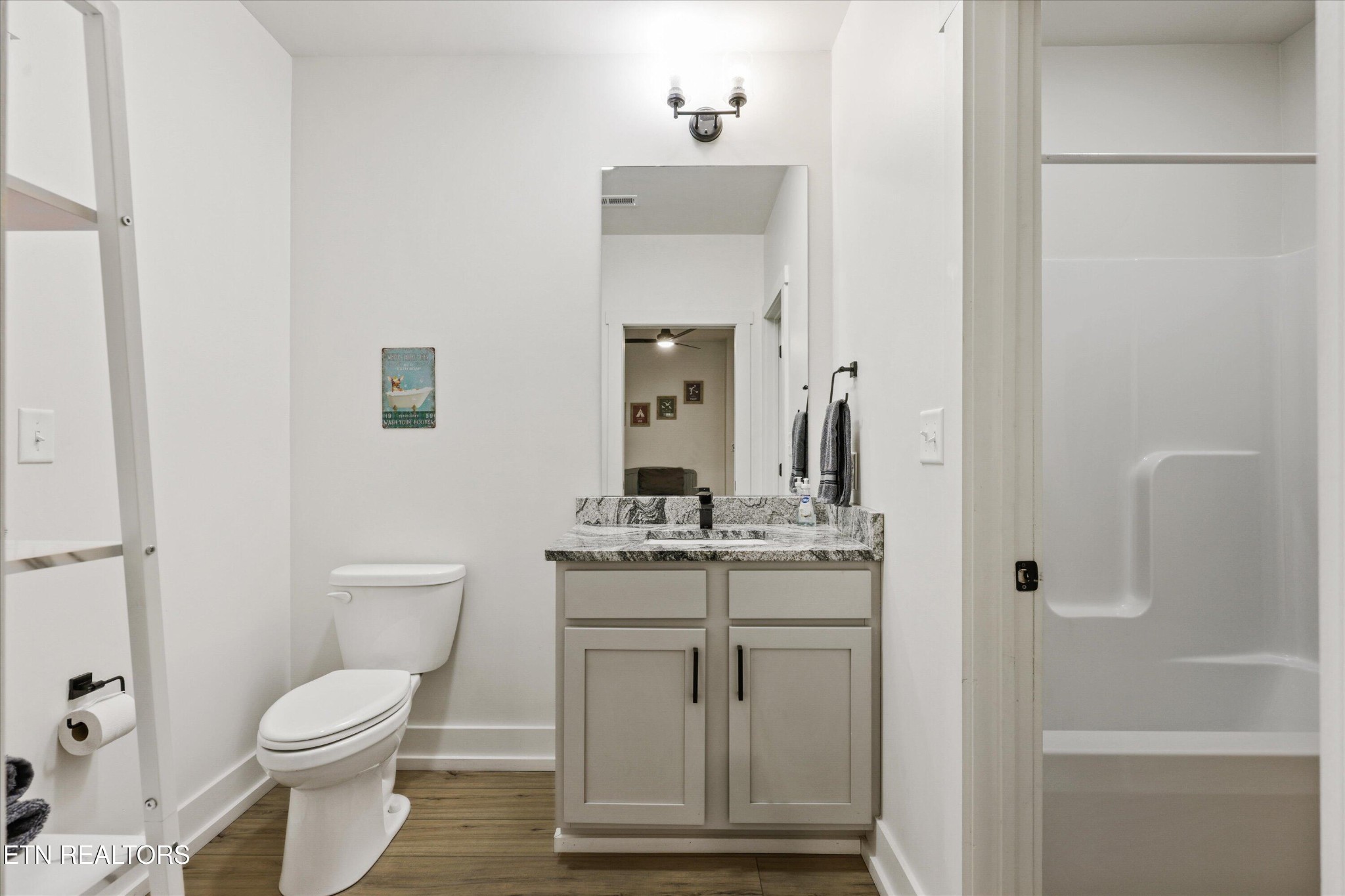 418 Fleeta Williams Way Sevierville, TN 37862 - Photo 19 of 39 a bathroom with a granite countertop toilet sink and mirror